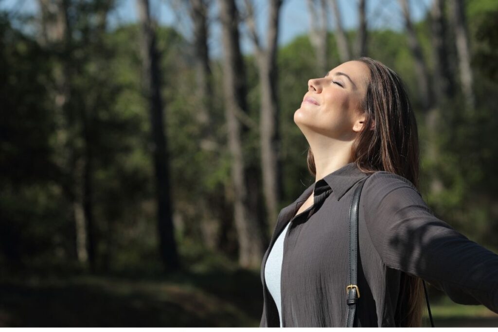 Woman breathing freely outdoors after quit smoking hypnosis in Washington DC Hypnosis center